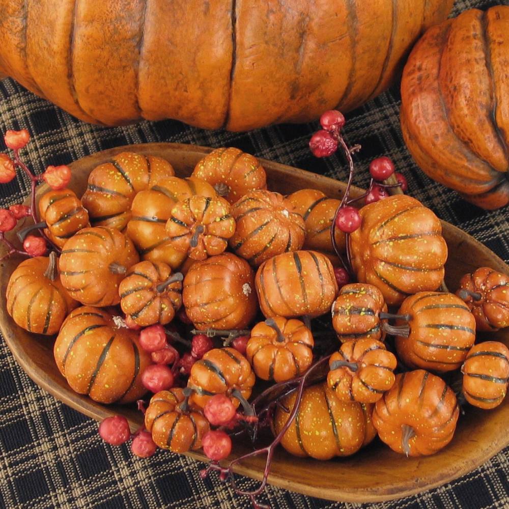 Multiple brilliant orange mini pumpkins in lightweight Styrofoam